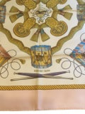 Close up picture of the Hermes brand appearing in a used Hermes scarf Les Tambours