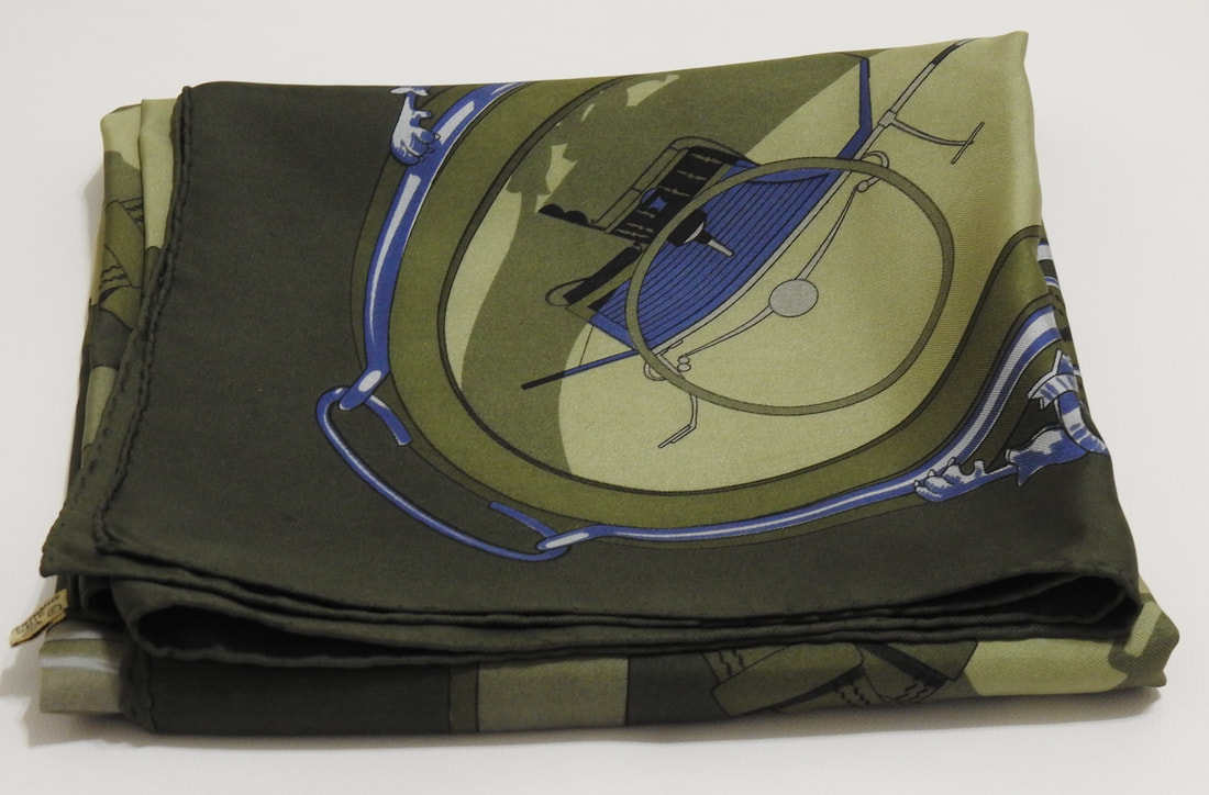 Picture of used Hermes 90cm silk scarf for sale. Moyeux by Vladimir Rybaltchenko in olive green was released in 1978