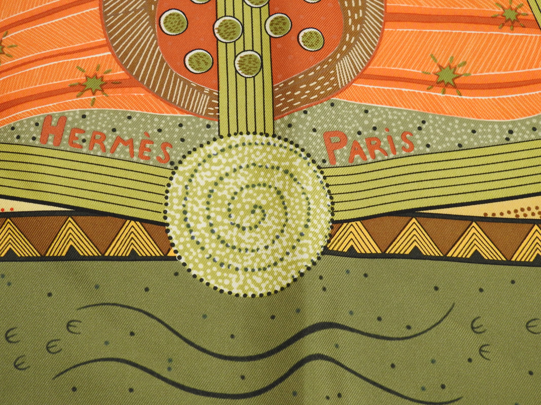 Close up picture of the Hermes brand appearing in a used Hermes 90cm silk scarf Reve d'Australie
