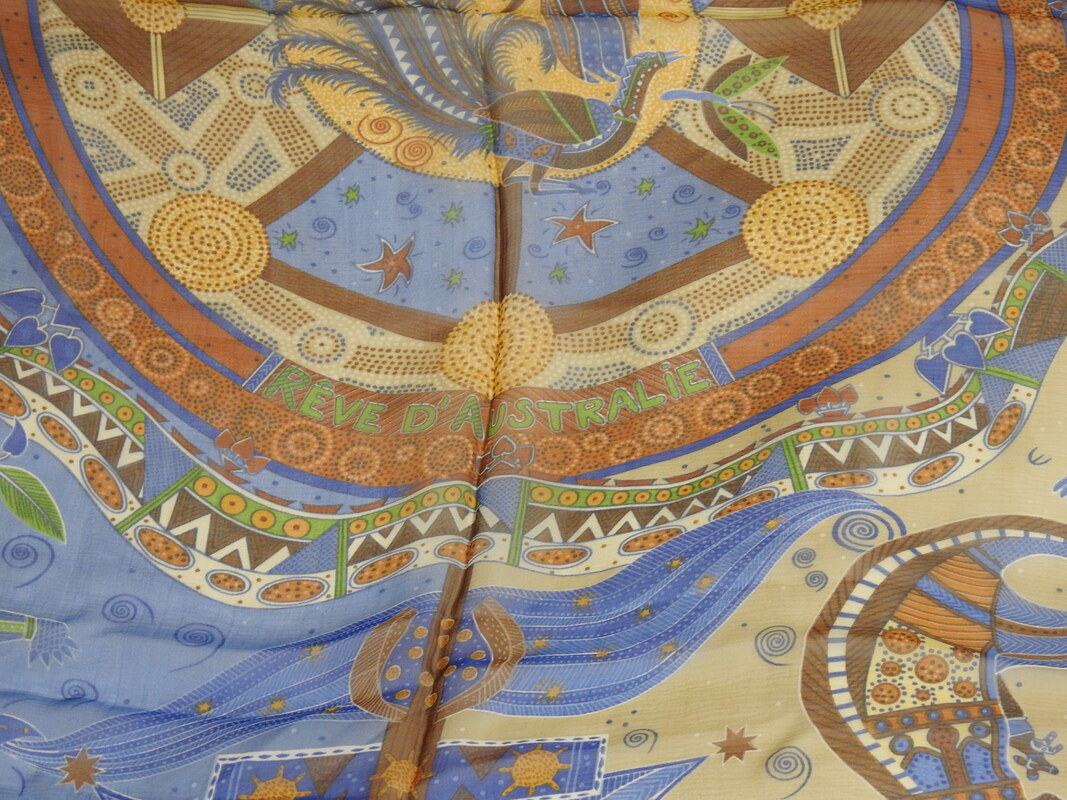 Close up picture of Reve d'Australie, a blue and brown Hermes 140cm silk mousseline scarf issued in 2000. Designed by Zoe Pauwels, it celebrates Australian wildlife