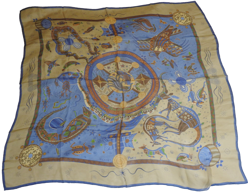 Picture of Reve d'Australie, a vintage Hermes 140cm silk mousseline scarf designed by Zoe Pauwels. Blue and tan and brown, this is a celebration of aboriginal art