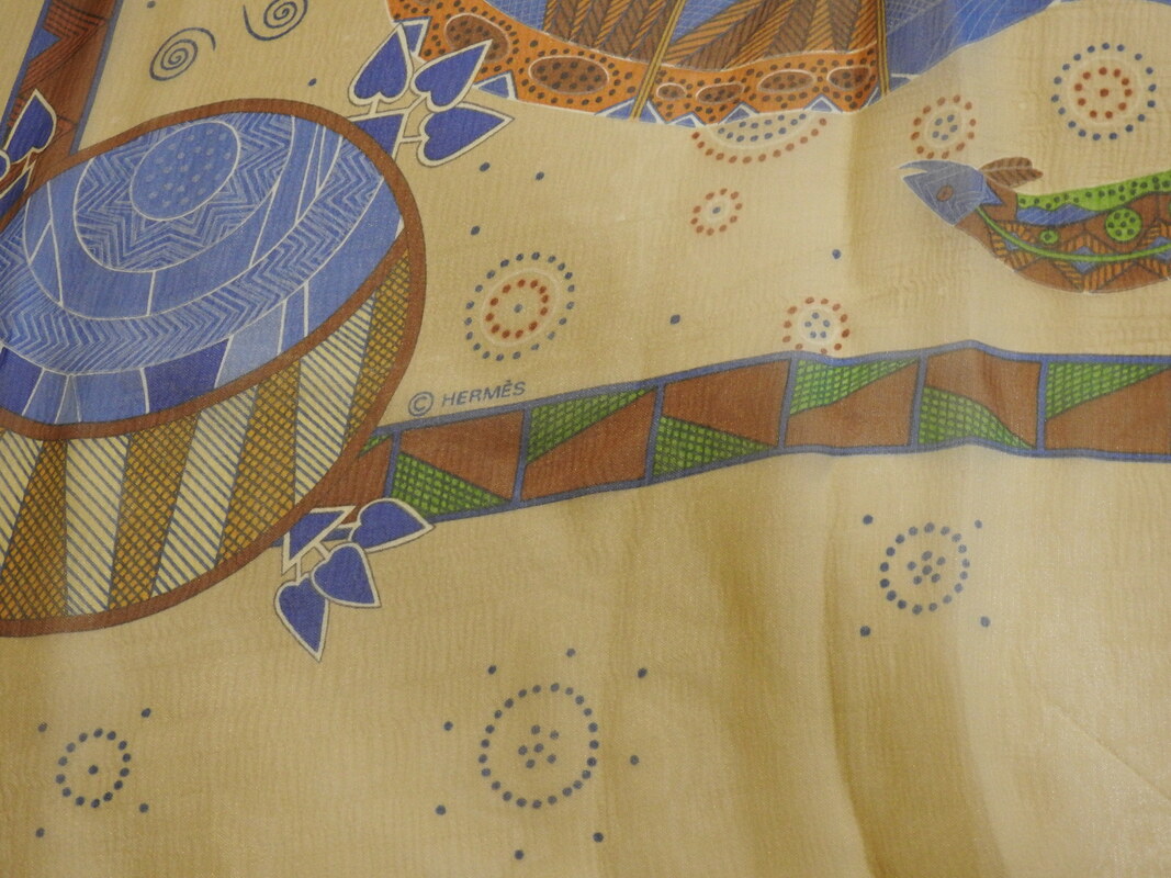 Close up Picture of copyright in used Hermes 140cm silk mousseline scarf for sale Reve d'Australie, a celebration of Australian aboriginal art in a dream time theme