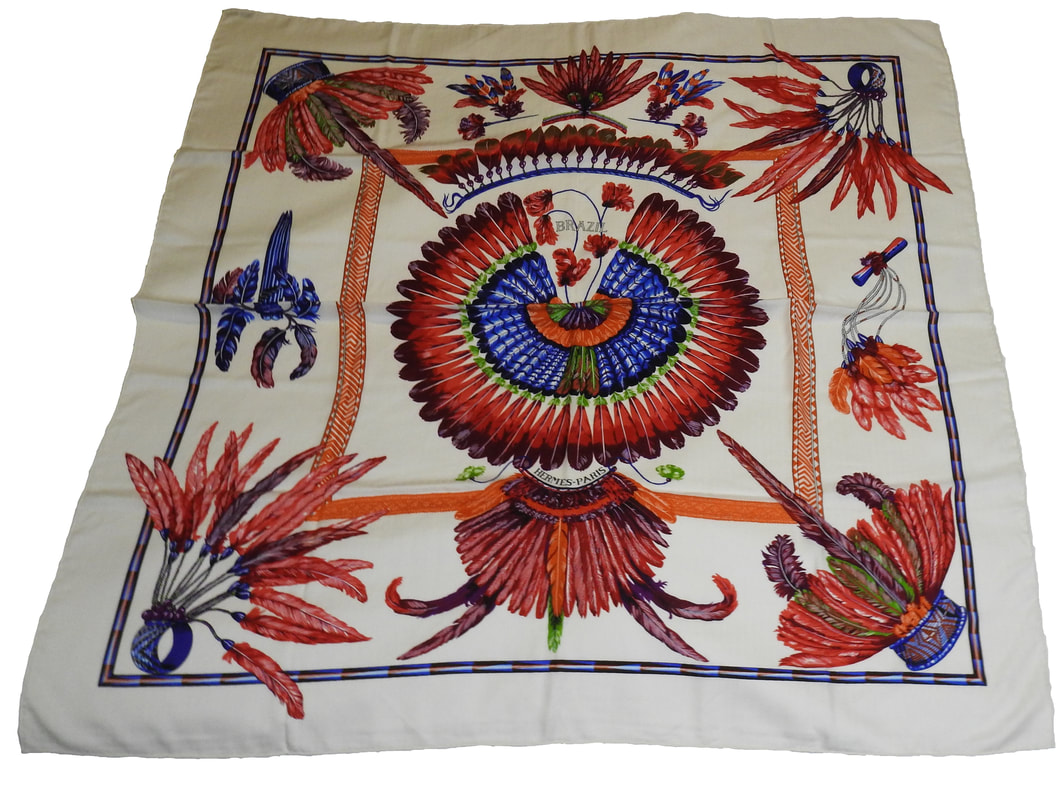 Picture of Brazil, a vintage Hermes 140cm silk cashmere scarf designed by Toutsy. White background with red and blue feathers