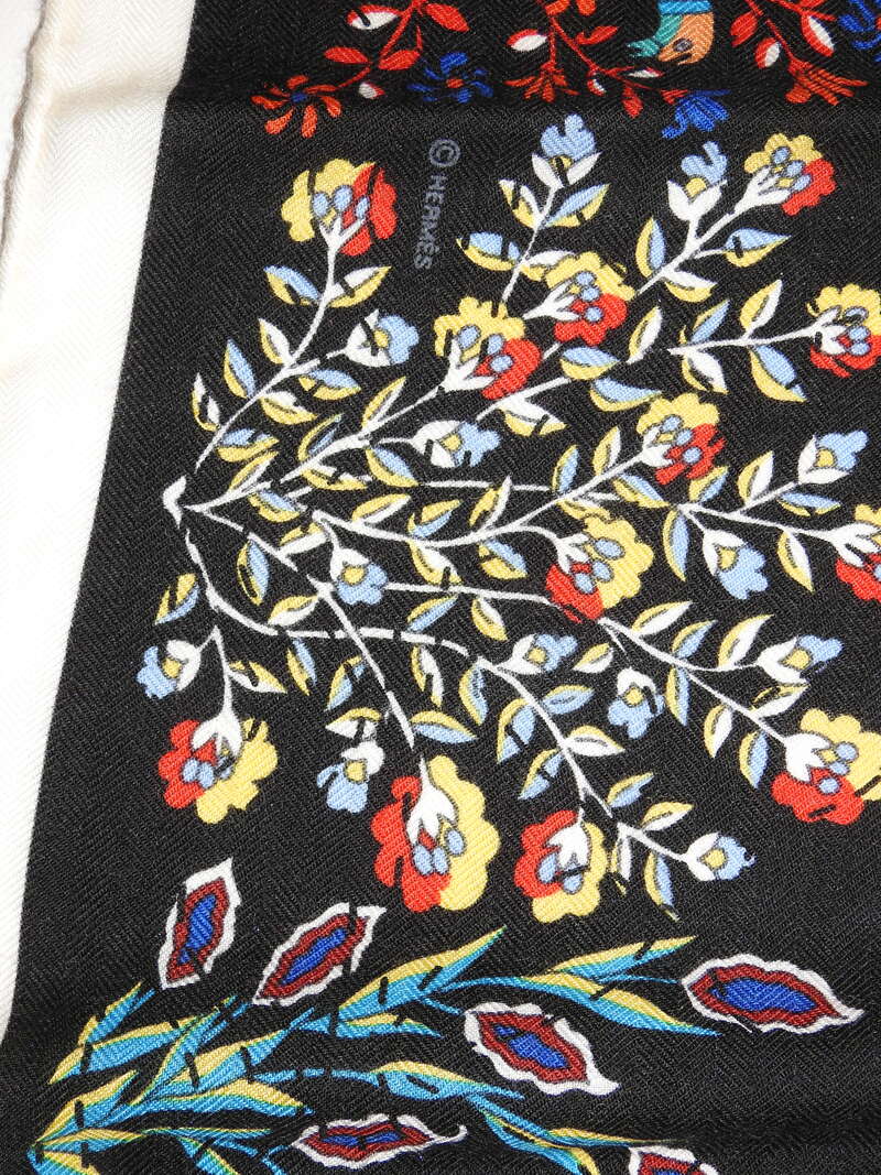 Close up Picture of the Hermes copyright in a vintage 140cm Hermes cashmere shawl. Pique Fleuri en Provence was designed by Christine Henry and issued in 2013
