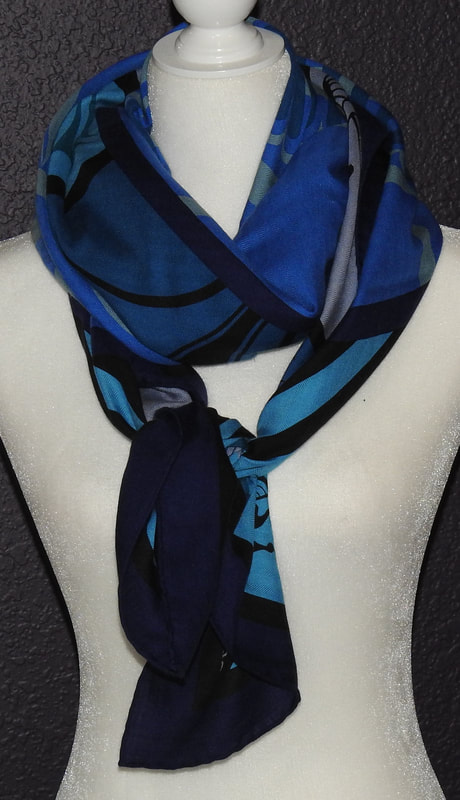 Picture of used Hermes 140cm silk and cashmere scarf for sale. Geometrie Cretoise by Julia Abadie in blue. Theme is tied to Greek art. This is tied loosely around the neck
