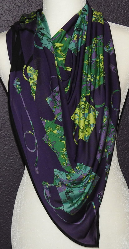 Picture of purple Hermes scarf in silk jersey fluide, Kelly en Caleche, tied in a cowboy knot