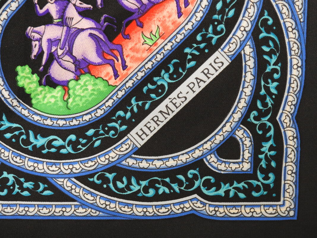 Close up picture of the Hermes brand appearing in a used Hermes scarf Qalamdan