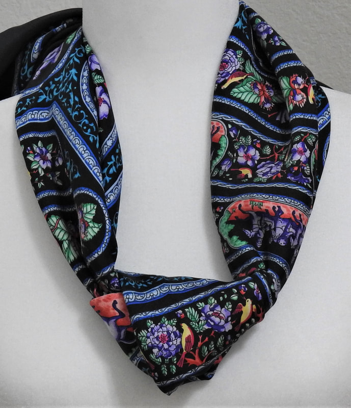 Picture of Qalamdan, a used Hermes 90cm silk scarf for sale. This black colorway is knotted in a bias fold