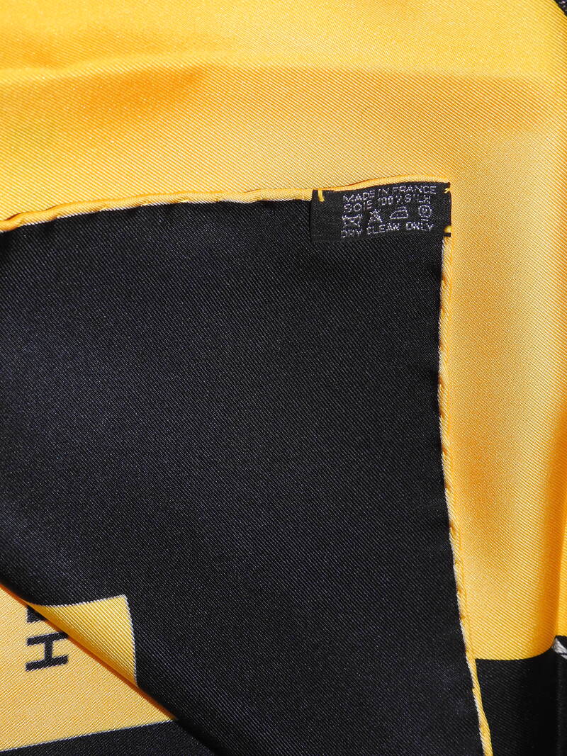 close up picture of the caretag attached to rare vintage Hermes 90cm silk scarf Regarde Paris in black and yellow colorway