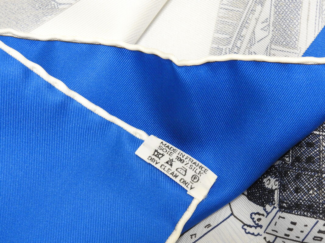 close up picture of the caretag attached to rare vintage Hermes 90cm silk scarf Regarde Paris in black colorway