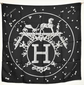 Picture of a 90cm silk Hermes scarf. Vif Argent was designed by Dimitri Rybaltchenko. Black background with white ex libris motif