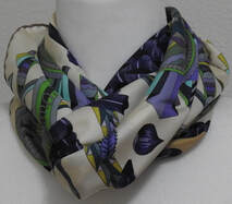 Picture of a knotted Hermes 90cm Silk Scarf, L'Ombrelle Magique by Pierre Marie, in purple and green
