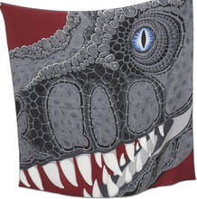 Picture of an Hermes 100cm cashmere mens scarf. Grey T rex dinosaur with a blue eye on a brick red background
