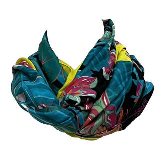 Picture of Toutsy's Flamingo Party pareo, a cotton scarf designed for Hermes. Yellow borders, black background, pink flamingos and green, orange and pink foliage. Tied in an infinity knot