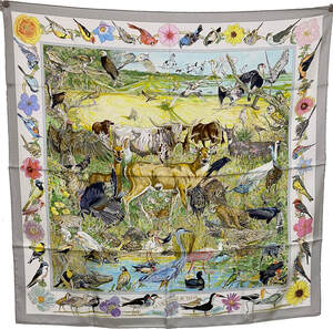 Picture of La Vie Sauvage du Texas, a vintage Hermes silk scarf. Produced in 2015, this Kermit Oliver design features 122 plants and animals native to Texas. Silver and gray colored border