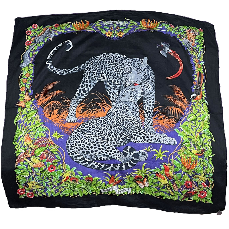 Picture of Hermes 100% cotton scarf, Jungle Love by Robert Dallet. Silver charm in one corner. Black border, green foliage, purple water and orange flowers