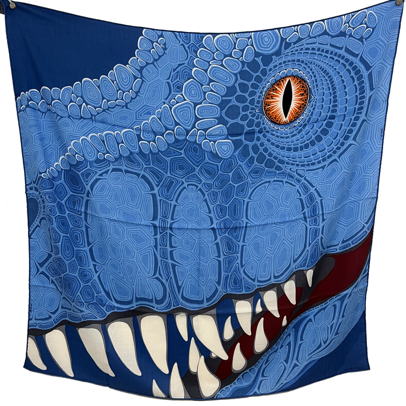 Picture of Aaaaargh, an Alice Shirley-designed men's 100cm cashmere Hermes scarf.  Blue dinosaur with orange eye