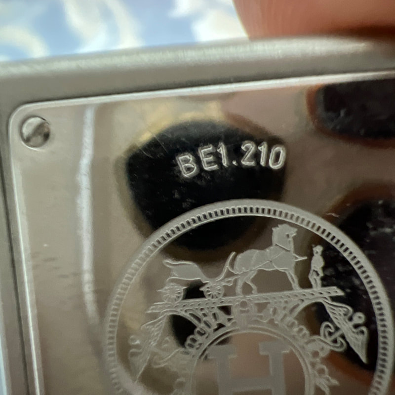 Picture of back of Hermes Belt watch face showing Ex Libris logo and BE1.210