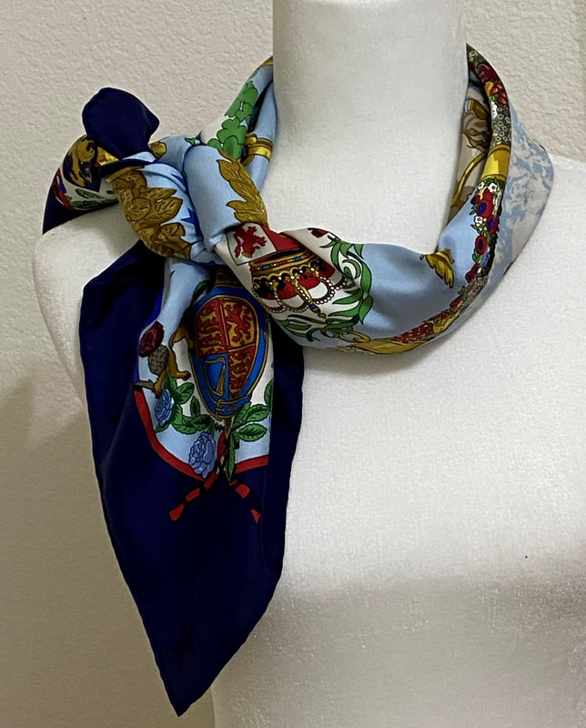Picture of used Hermes 90cm silk scarf for sale. Emblemes de l'Europe by Caty Latham, light blue and navy blue with star jacquard weave. Knotted loosely around the neck