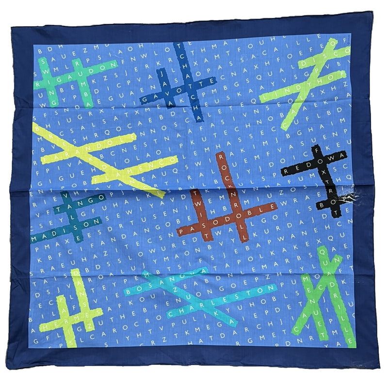 Picture of a 70cm cotton scarf from Hermes. Danse is blue with a marine blue border. White letters spell out names of dances in a find-a-word manner, highlighted by yellow, green, brown and black Hs