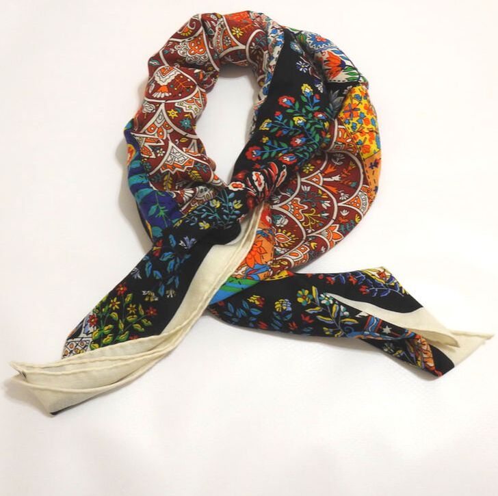 Picture of vintage 140cm Hermes scarf. Cashmere shawl titled Pique Fleuri en Provence, designed by Christine Henry. Black with orange, red, blue, green and white flowers