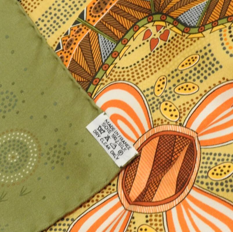 Picture of the caretag attached to Reve d'Australie, a green and brown 90cm Hermes silk twill scarf