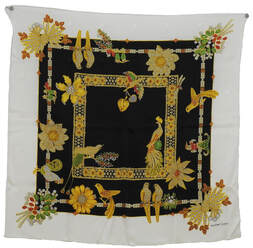 Picture of a silk scarf by Must de Cartier. White border, black interior, gold rope. Jacquard weave