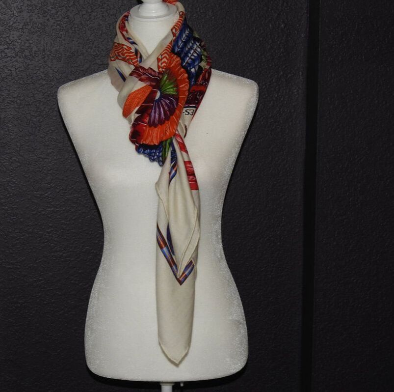 Picture of vintage 140cm Hermes scarf. Cashmere shawl titled Brazil, designed by Toutsy. White with orange, red, blue, green and purple feathers