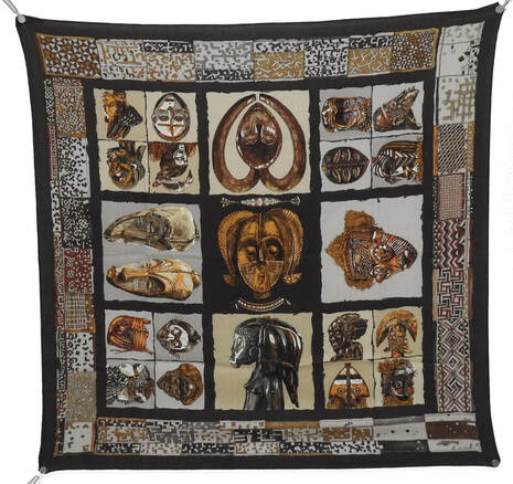 Picture of Persona, a 90cm cashmere scarf designed by Loic Dubigeon for Hermes. Brown and creme African masks.