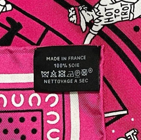 Picture of caretag on Hot to Trot, a used Hermes 55cm silk scarf for sale. This scarf bright pink