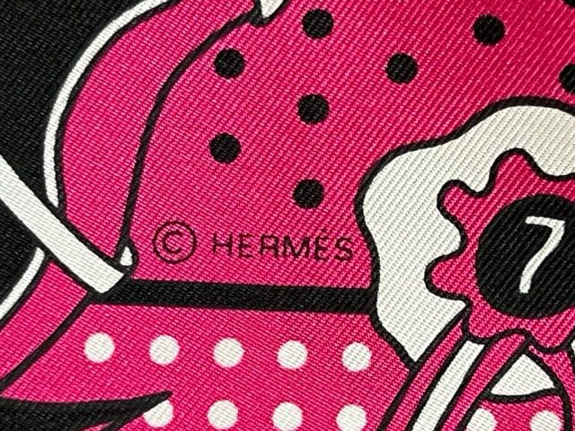 Close up Picture of Hermes copyright on Hot to Trot, a 55cm Hermes silk bandana scarf in hot pink