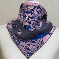 Picture of Quatre Chevaux, a 45cm Hermes mens silk gavroche, tied in a cowboy knot. Designed by David Bartholomeo. Pink, grey and blue silk scarf